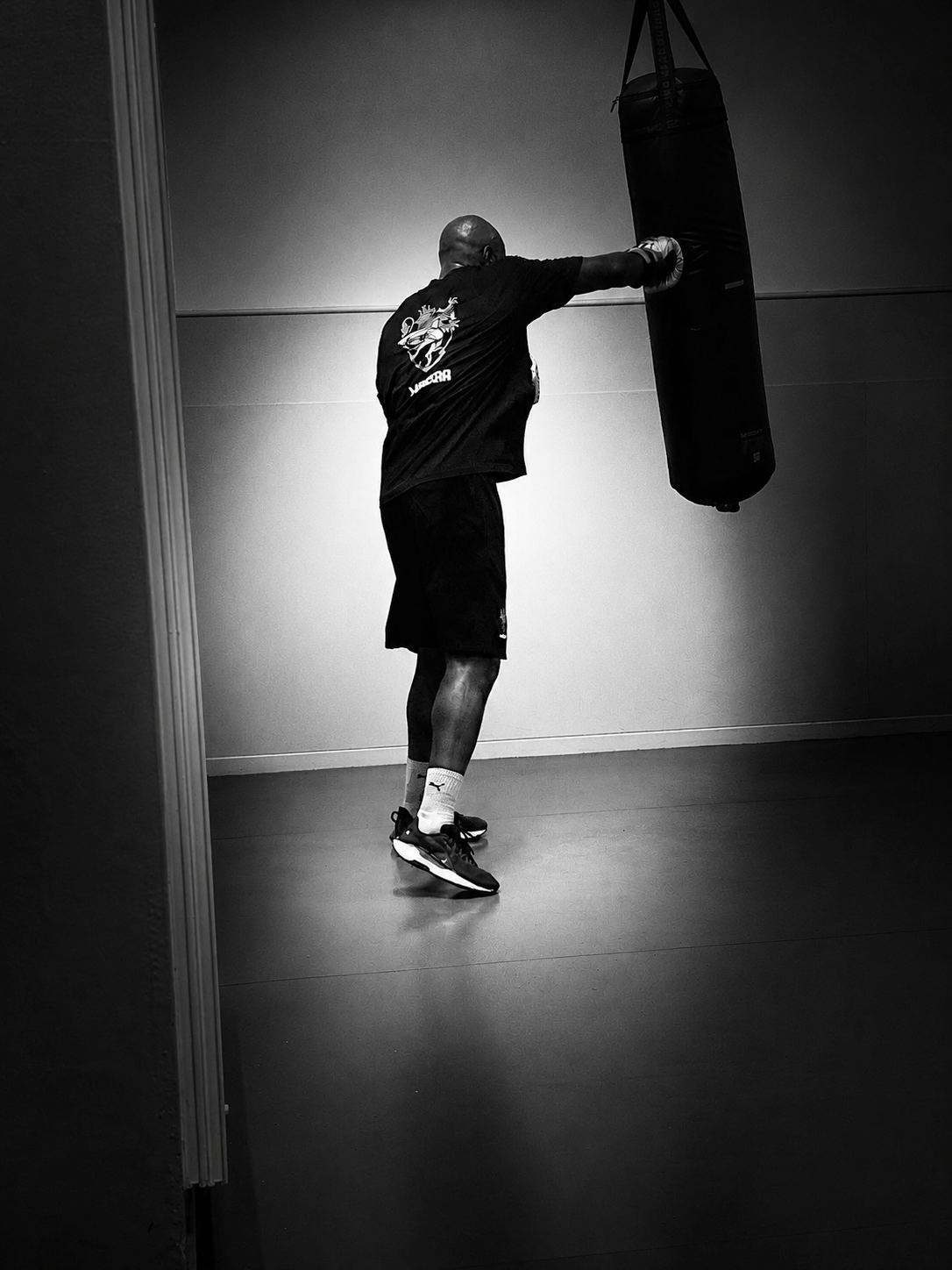 Training — working the heavy bag in an empty gym